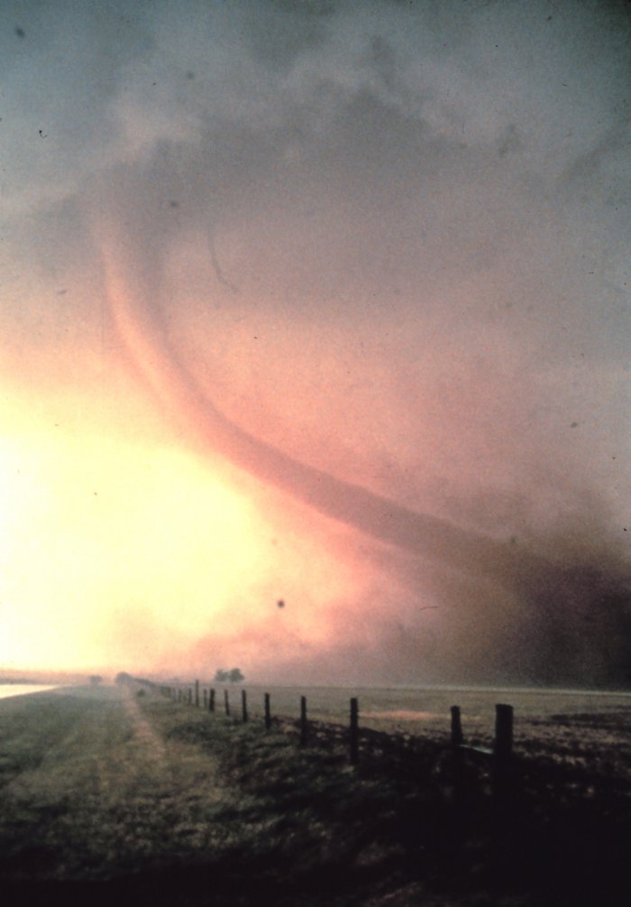 A cyclone looms across a barren landscape.